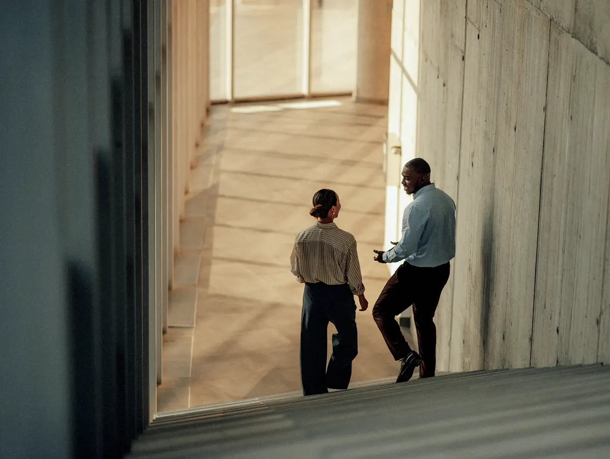 Two professionals talking in an office building