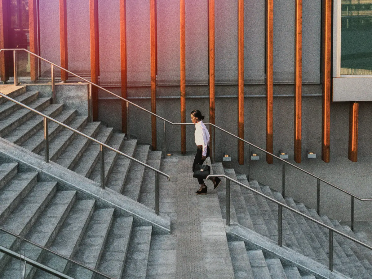 Person walking down wide concrete stairs