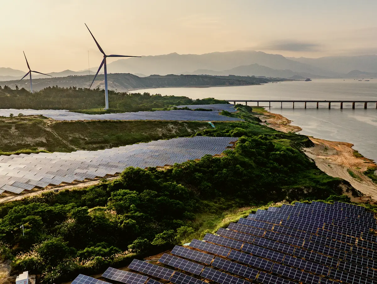 Wind turbines and solar panels by the coast